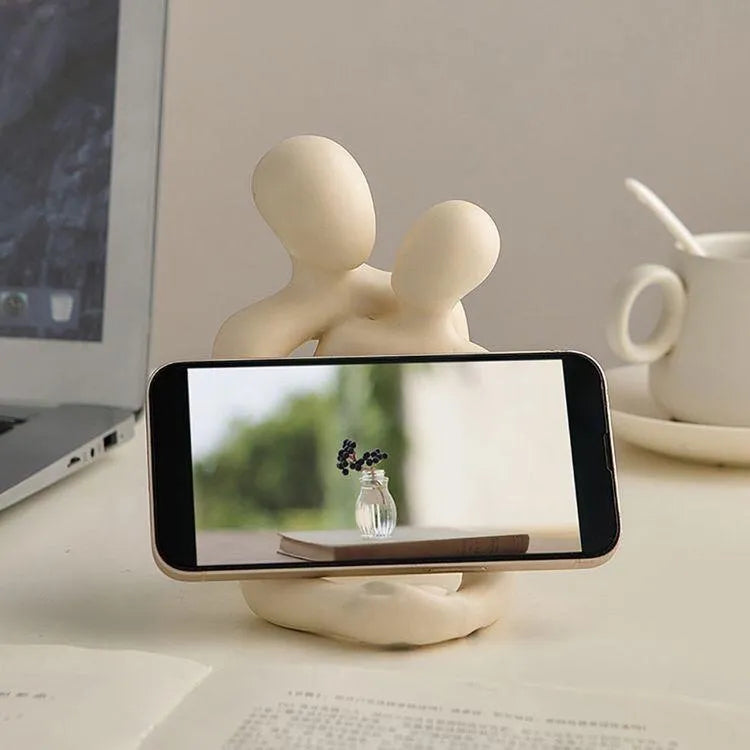 Modern couple resin statue in milky white or gold colour on a desk or shelf
