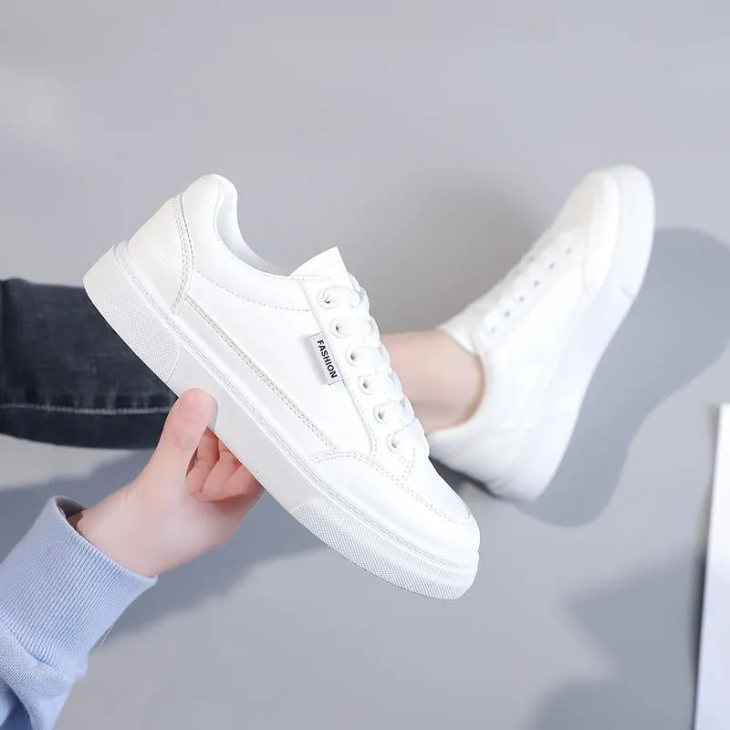 Korean style white and brown low-top women's sneakers on a solid background.