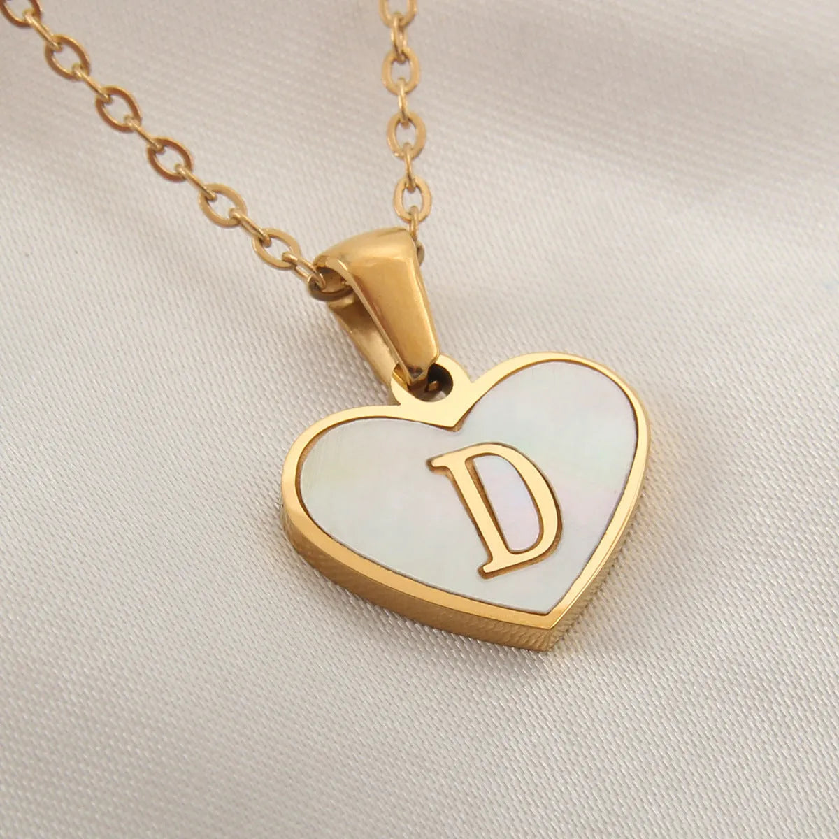 Gold heart necklace with white shell pendant and initial charm on 45cm adjustable chain