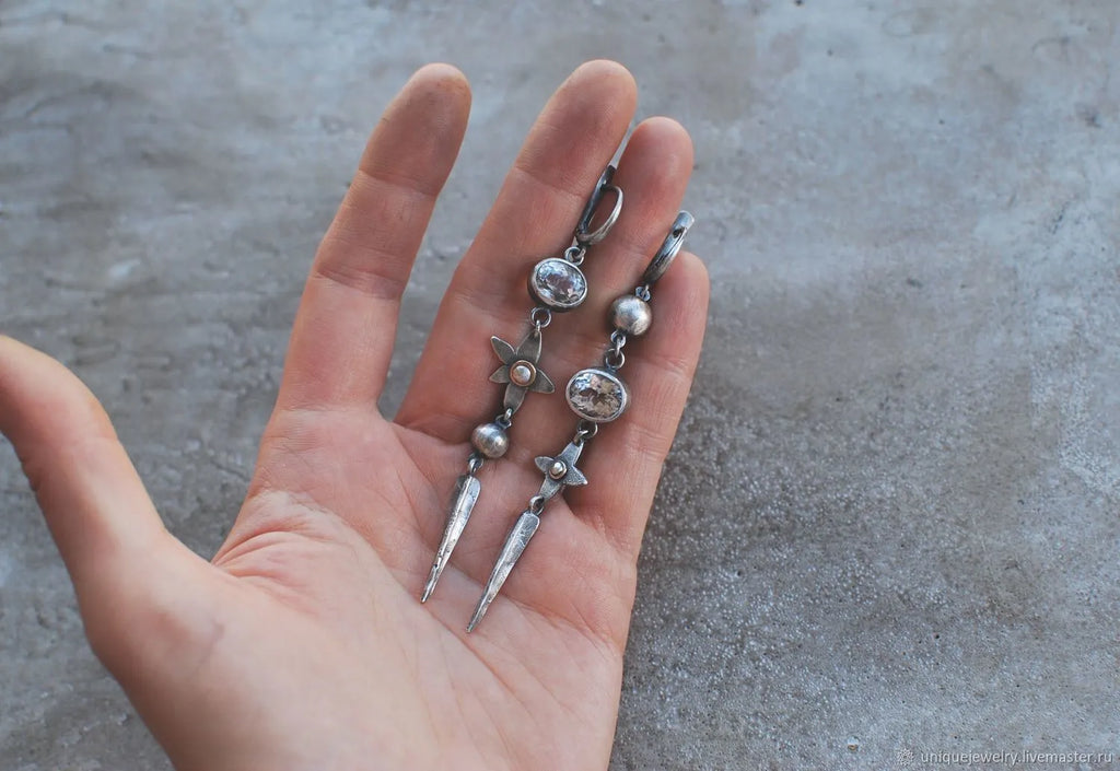 Geometric antique silver long drop earrings with rhinestones and a XINGX design motif.