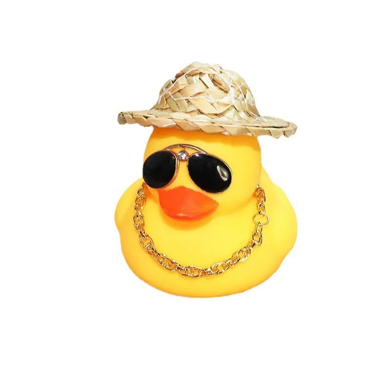 Cartoon yellow duck car ornament wearing a straw hat and sunglasses