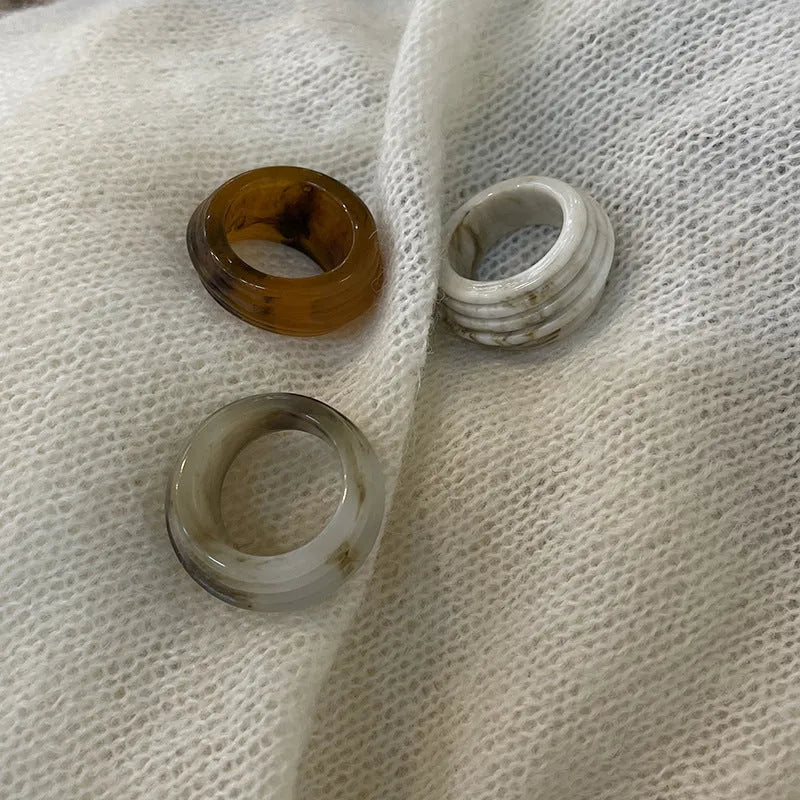 Chinese style resin ring with geometry shape and irregular width in brown or white.