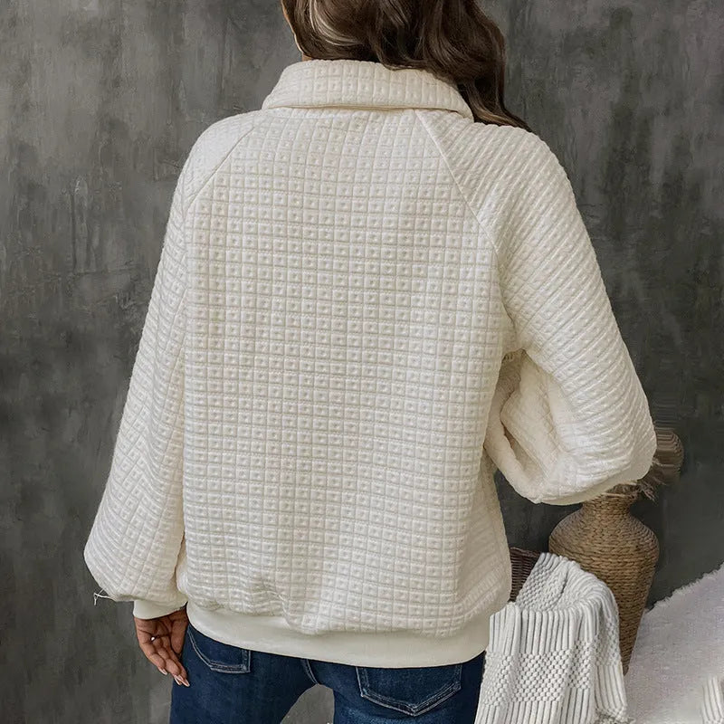 Women's milky white textured polo collar chunky knit sweater laid flat.