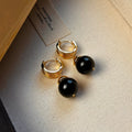 A pair of Fashion Maillard Tigereye earrings with a geometric shape and real gold plating, shown in brown and black colour options.