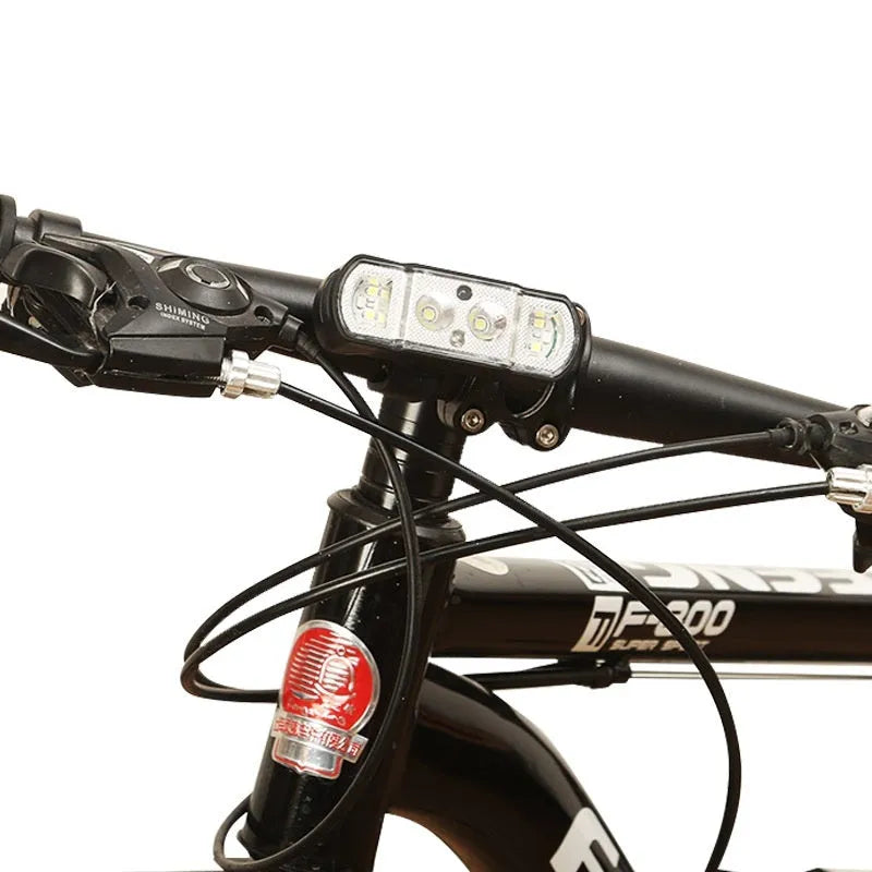 Black USB rechargeable bicycle headlight with wave induction sensor on a bike handlebar