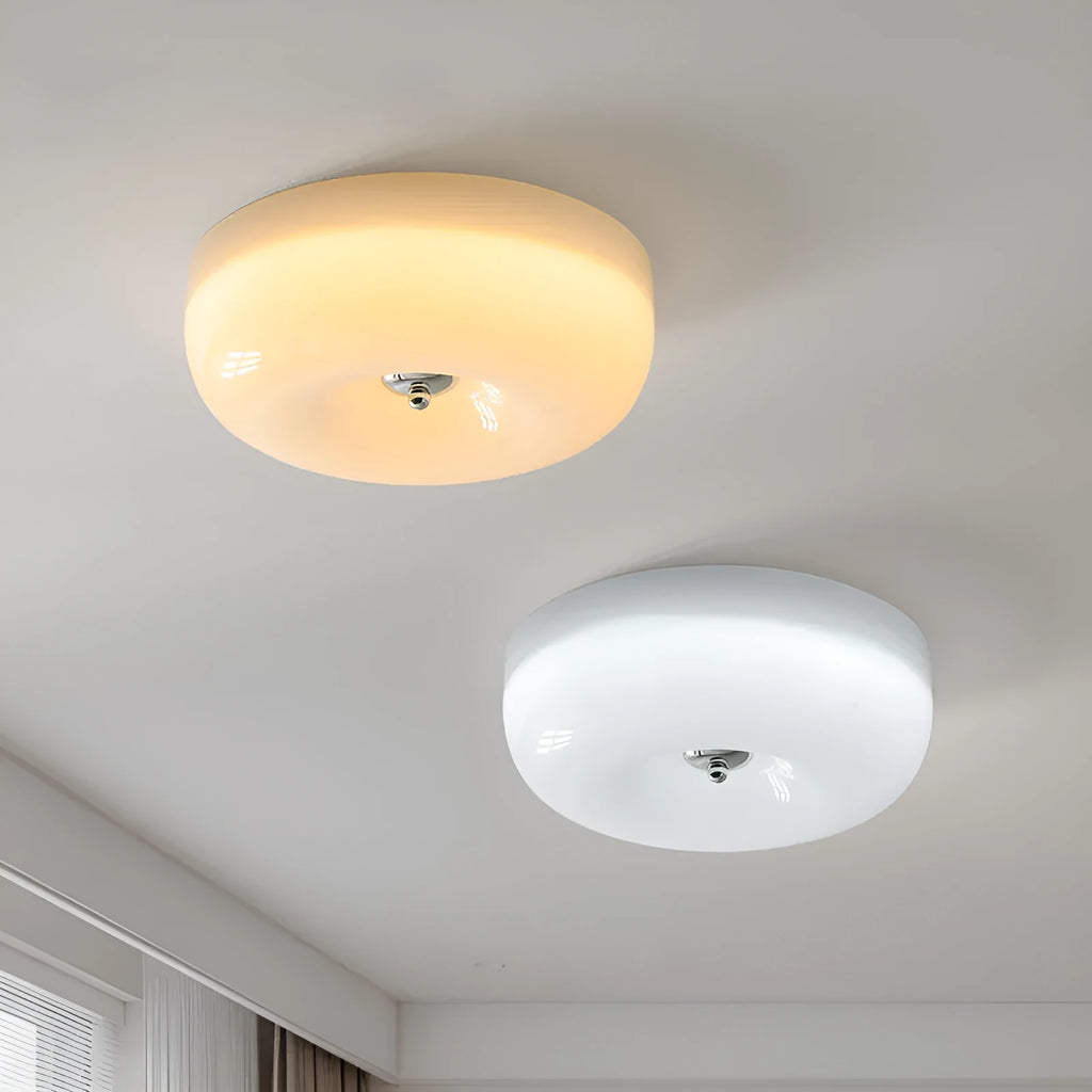American-style antique finish ceiling lamp with cream coloured shade in bedroom setting
