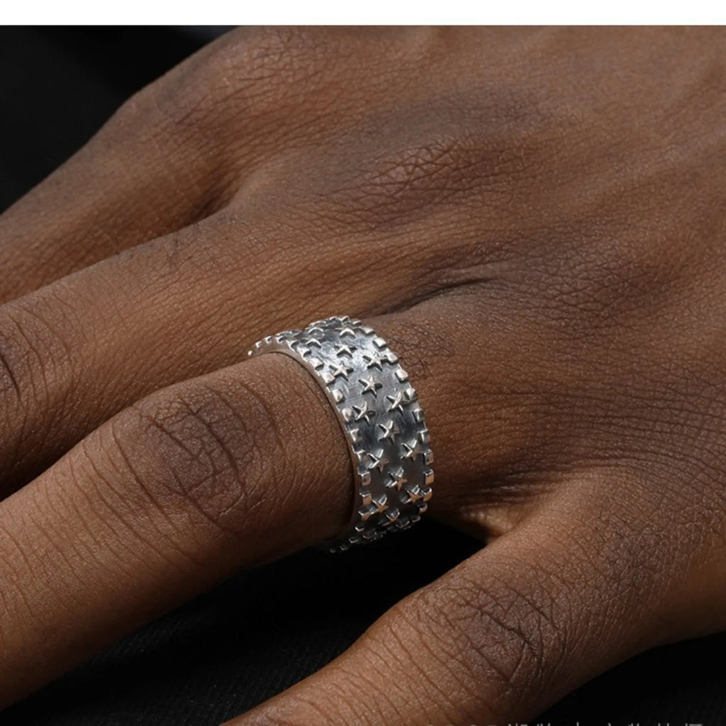 Adjustable silver ring with a multi-five pointed star geometric pattern on a solid 925 sterling silver band.