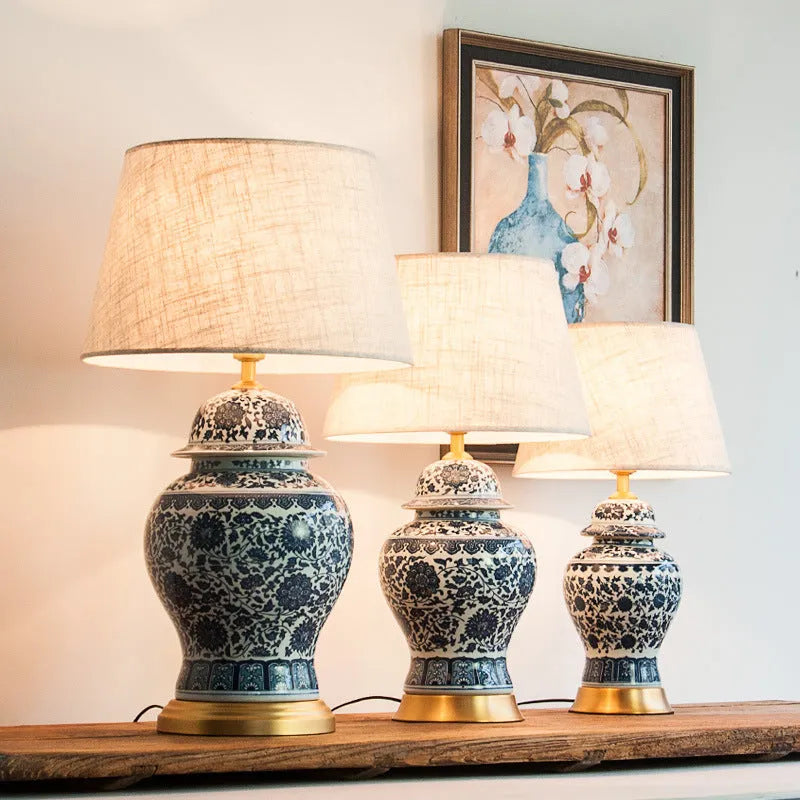 Chinese blue and white porcelain table lamp with cloth shade on wooden surface