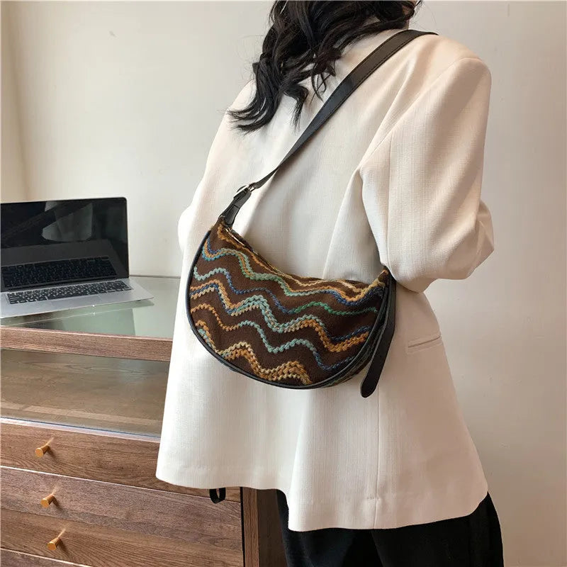 Women's straw woven crossbody bag showing internal phone and file compartments