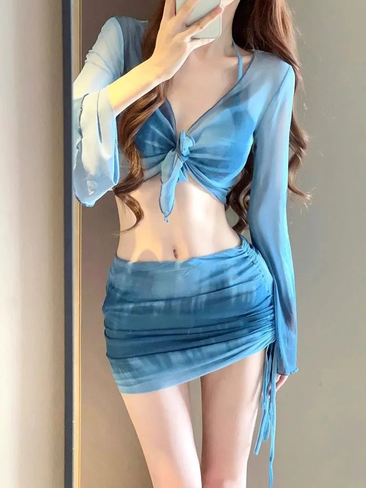 Blue high-waisted women's bikini four-piece set showing shirt, bra, underwear, and skirt.