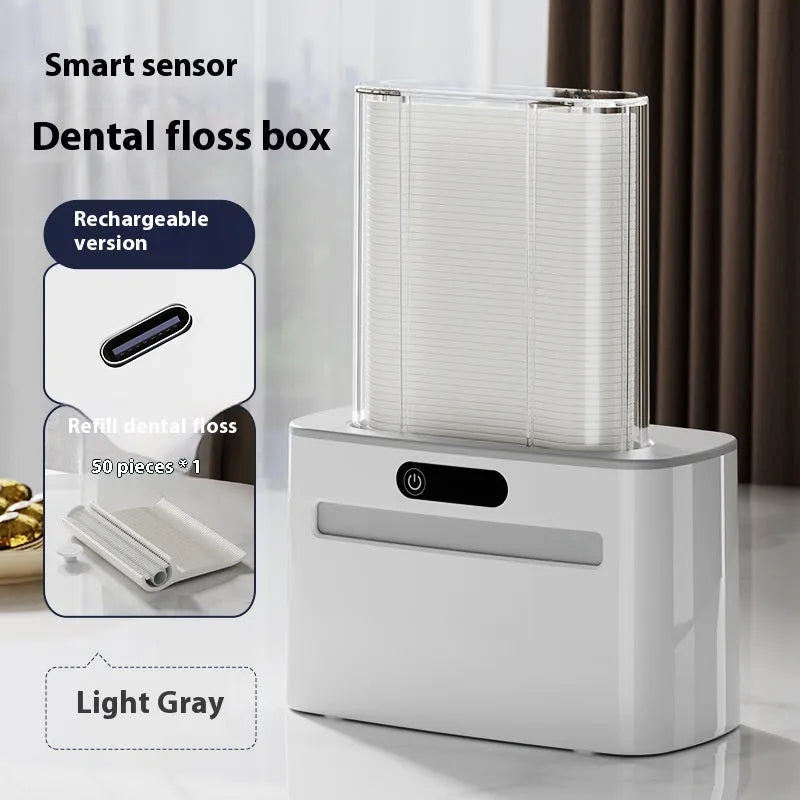 Dark grey automatic electric dental floss box with intelligent induction sensor on a bathroom countertop.