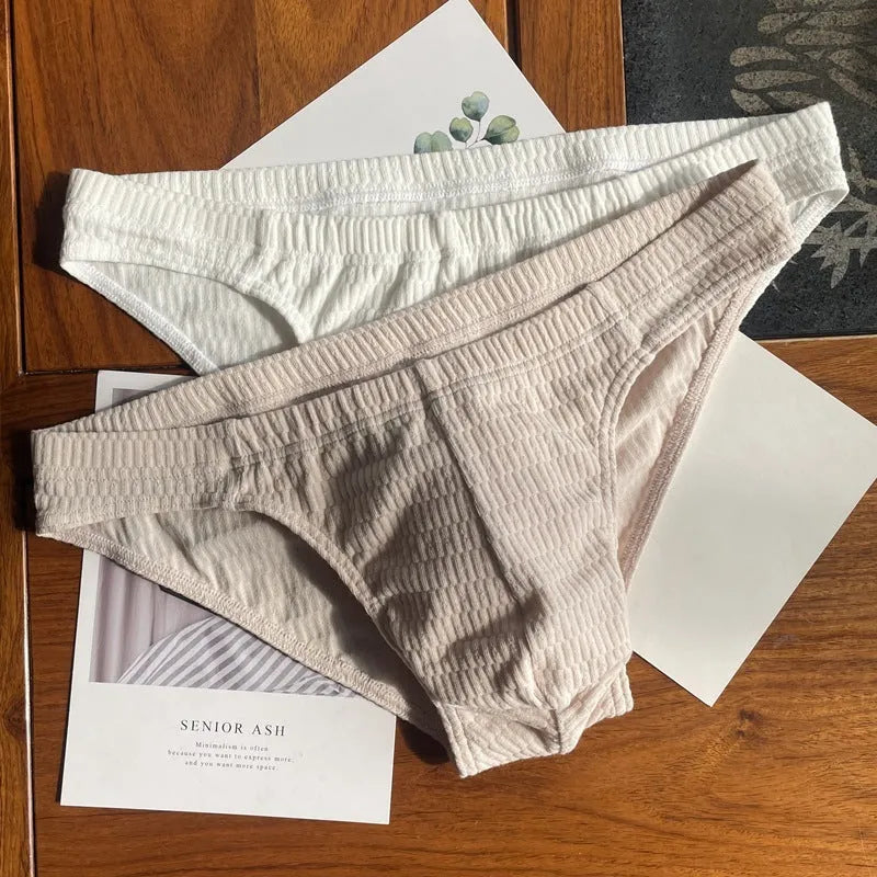 Men's solid colour cotton triangle underwear briefs on a mid-waist, shown in a skin tone colour.