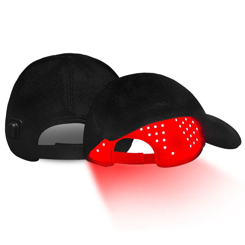 Black infrared duckbill hair growth cap with red LED lights and separate controller on table