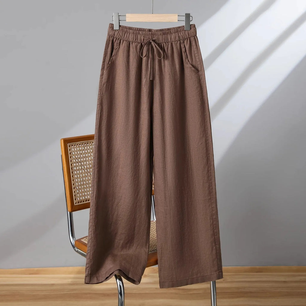 Women's straight leg casual trousers in khaki with an elastic waistband and lace-up drawstring detail.