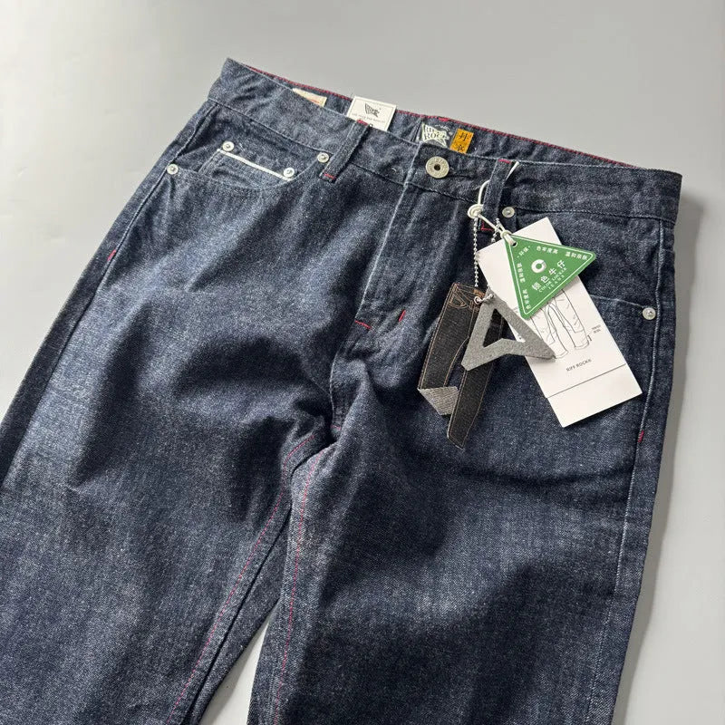 Men's primary blue straight-leg cotton denim trousers on a neutral background, showing mid-waist fit and trouser length.