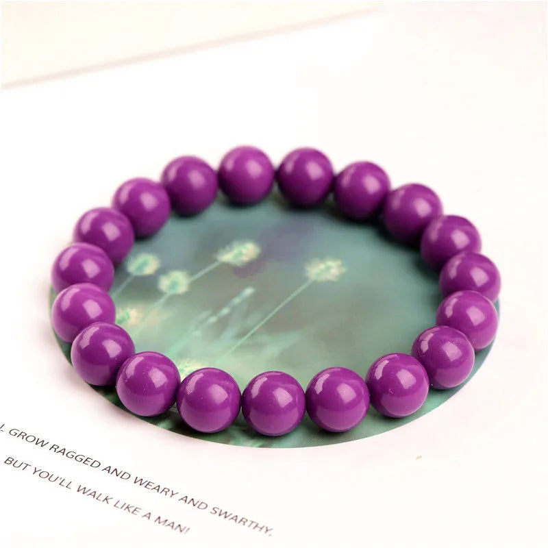 Polished purple mica crystal bracelet with original design on a wrist, showing 5A colour grade.