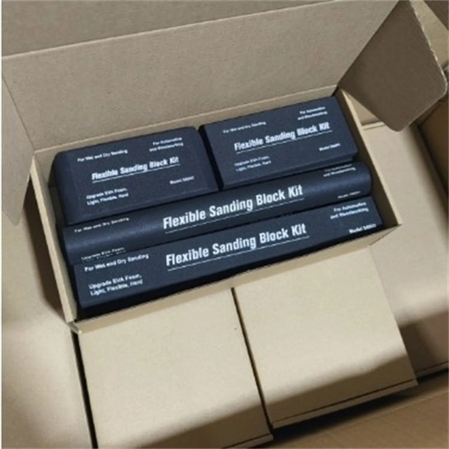 Set of seven black metal frosted blocks arranged together on a surface.
