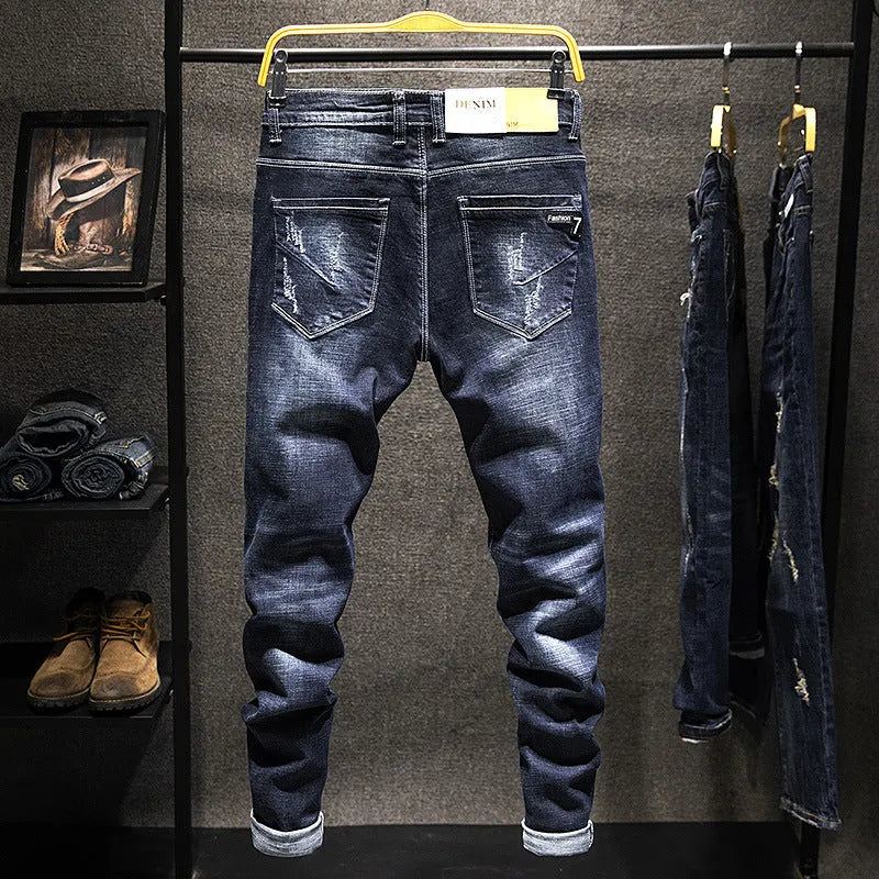 Men's slim-fit skinny jeans in dark blue cotton denim on a hanger.