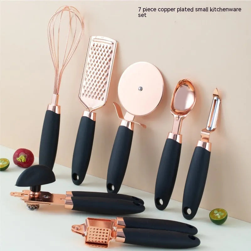 7-piece stainless steel kitchen tool set with copper plating peeler gadget in a cutlery rack on a countertop