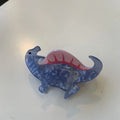 Dinosaur-themed acrylic jaw hair clip showing six colour variations with grip mechanism