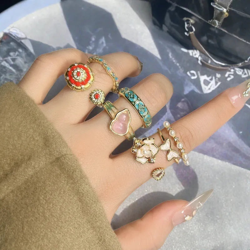Adjustable copper women's ring with vintage oil drip finish, gourd shape, and inlaid zircon stones in floral and bow designs.