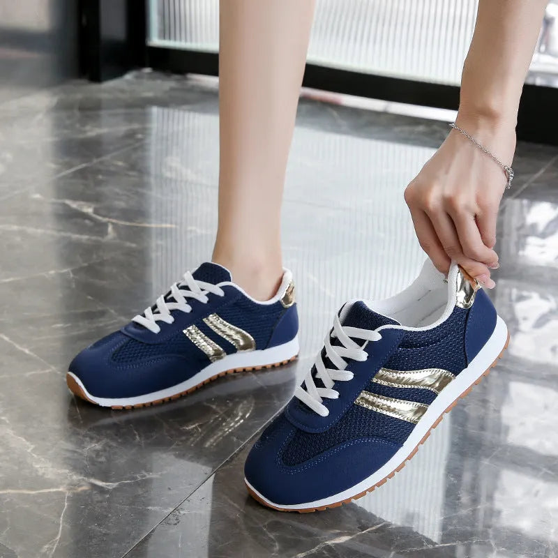Blue women's casual tennis shoes with cross shoulder straps and a flat rubber sole