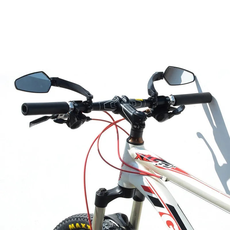 Black rotatable bicycle rearview mirror with large acrylic reflective surface mounted on handlebars.