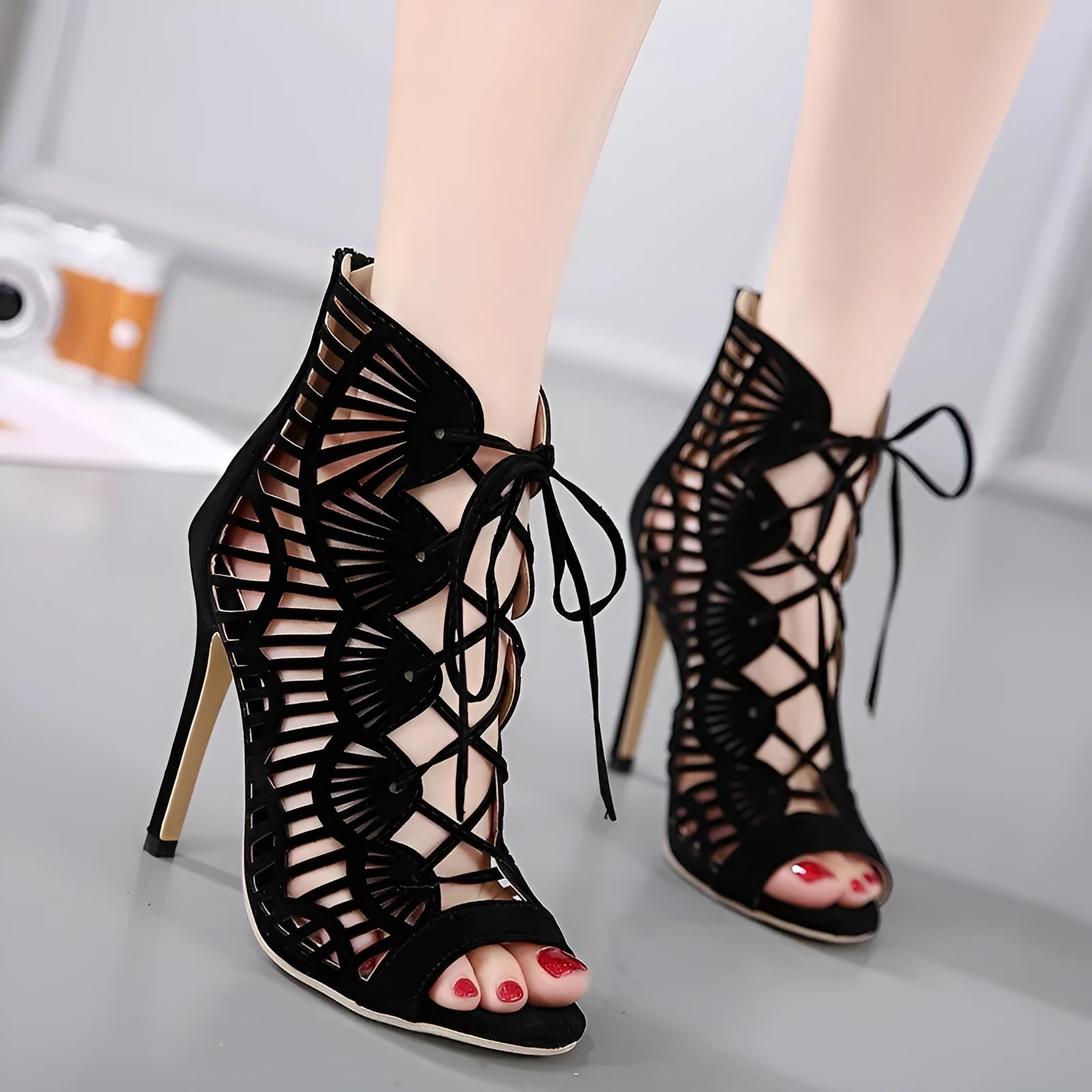 Black lace high heels with suede upper, fish mouth toe, stiletto heel above 8cm, and hollow design.