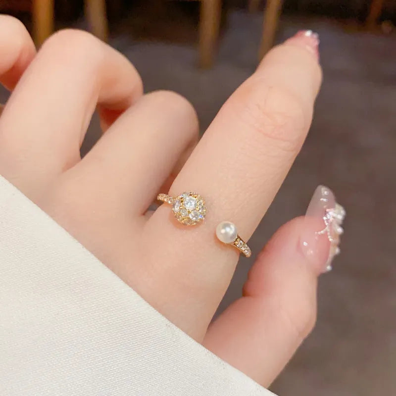 Open-end pearl ring with round zircon in gold plating on geometric copper band
