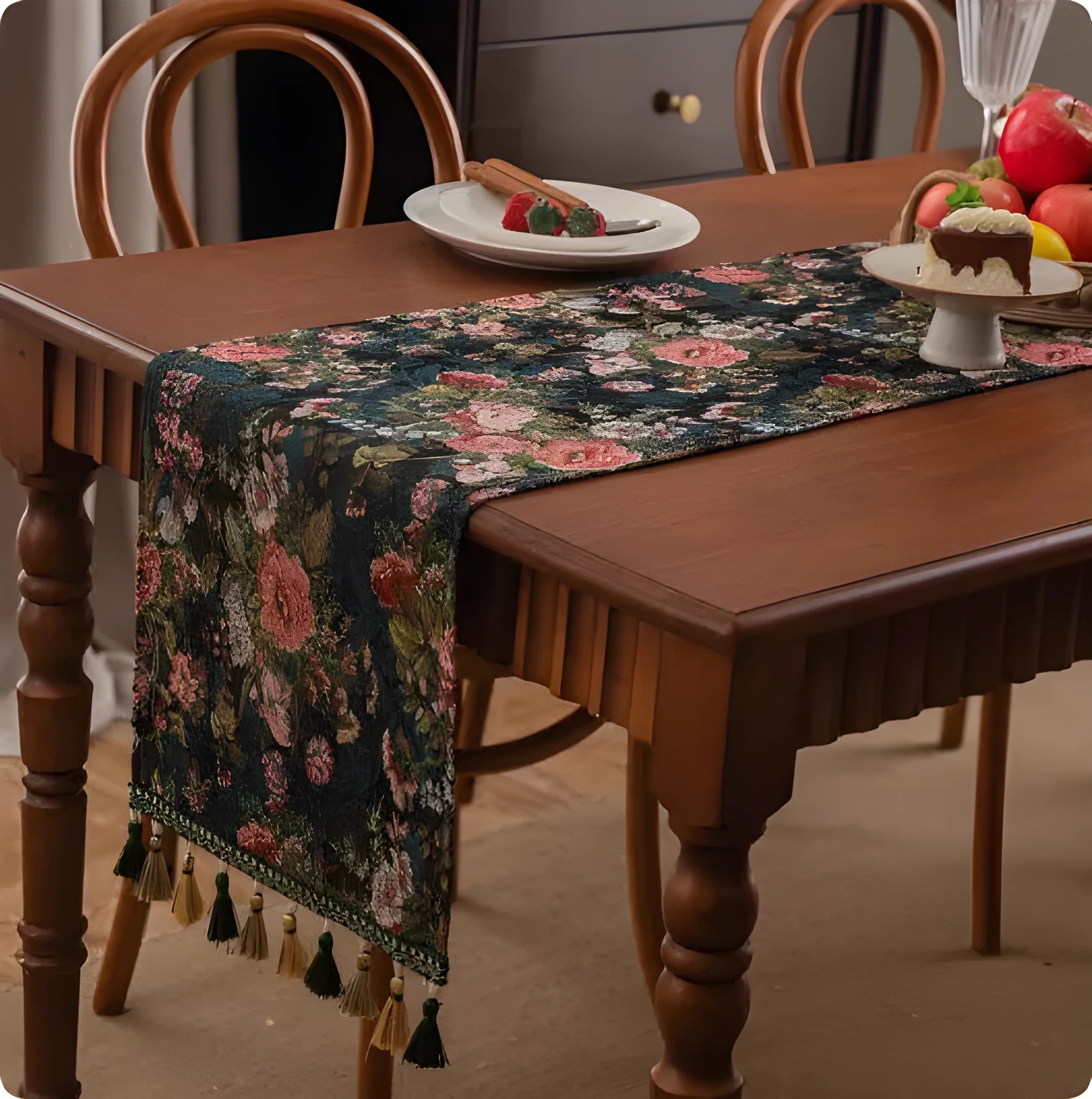 Long decorative table runner with handwoven tassels in a blue ginkgo leaf pattern on a wooden table.