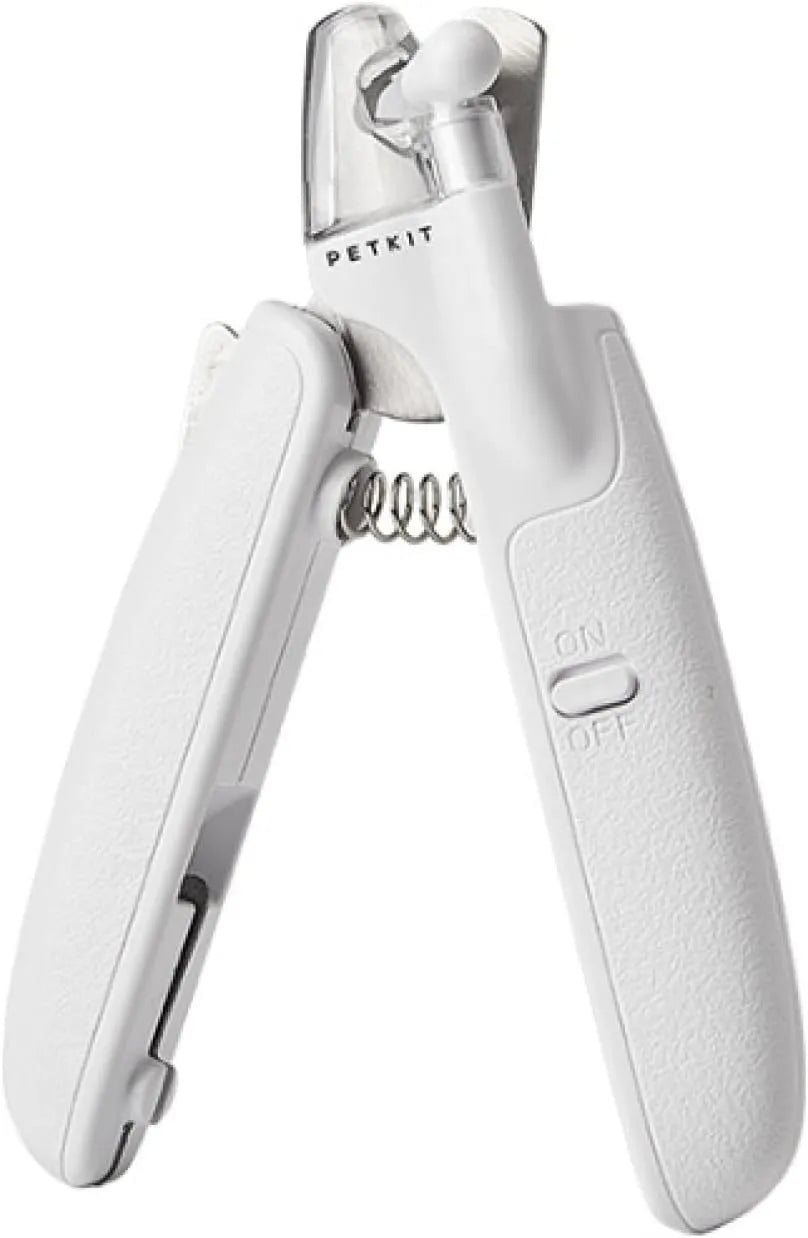 White LED pet nail clippers with transparent guard, triangular blade, and anti-slip handle next to a filing tool.