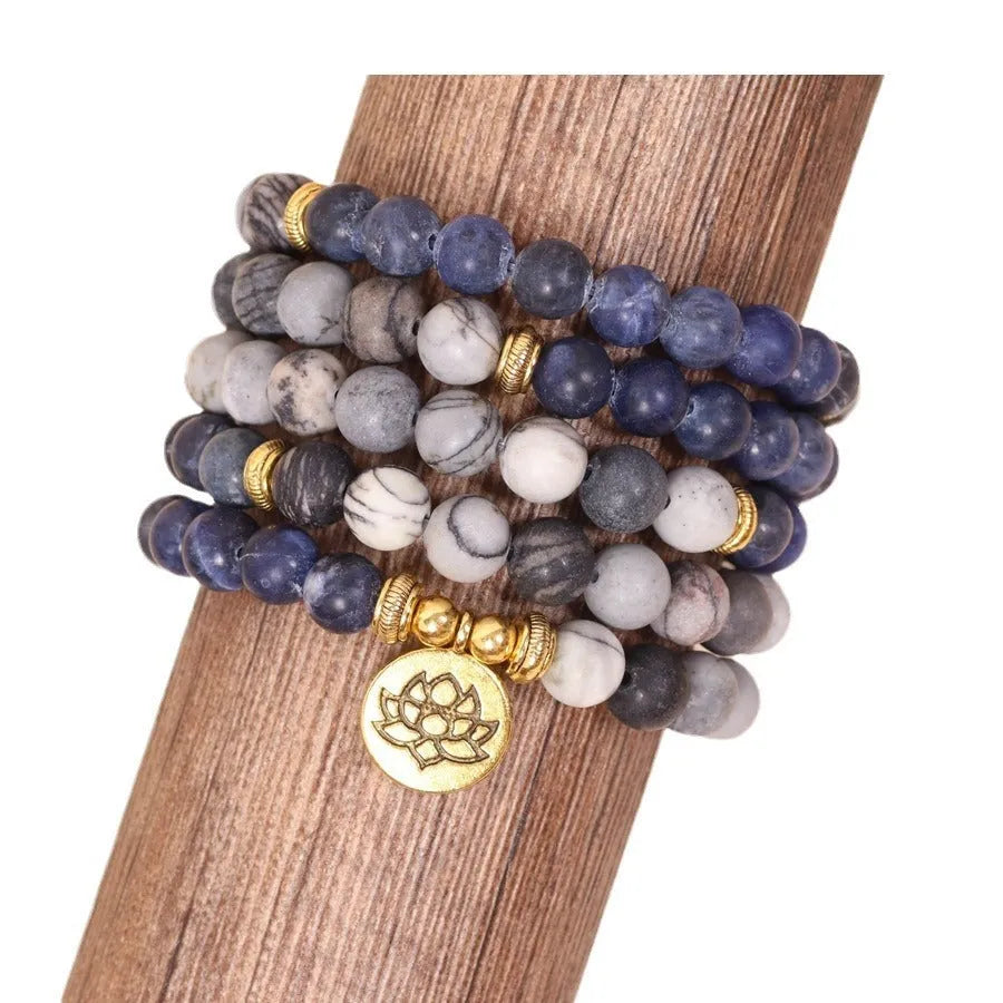 Blue multi-layer bracelet with patterned network stone beads on an alloy chain.