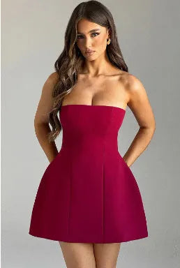 Women's solid colour backless tube dress with A-line skirt and high waist in various colours.