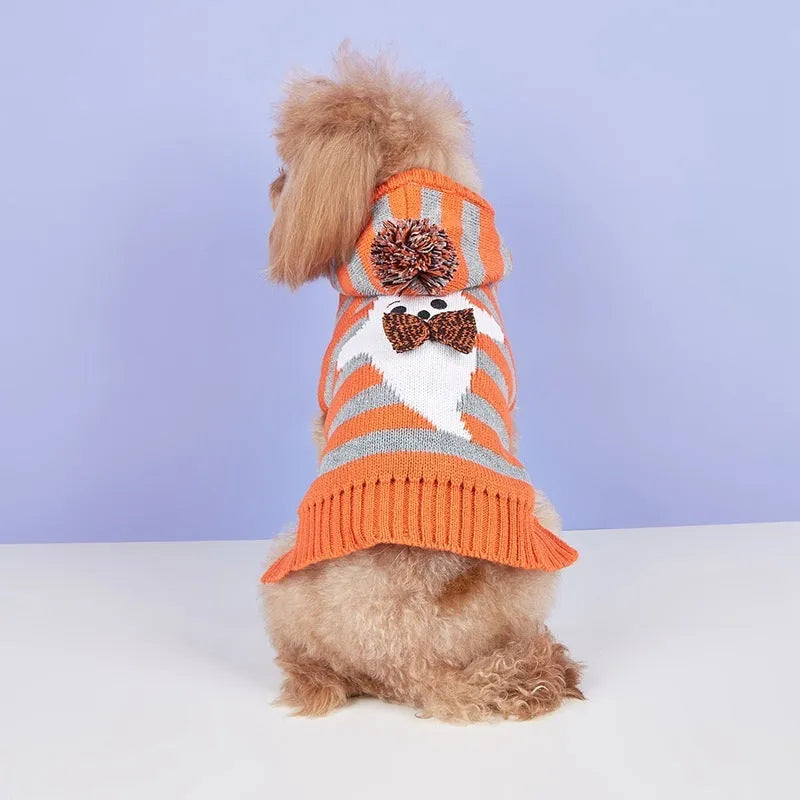 Orange knitted hooded pet sweater with striped pattern and fur balls for Halloween