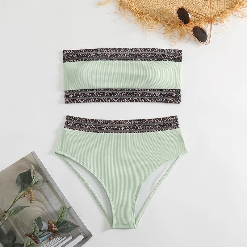 Black strapless leopard print bikini set with separate bra and shorts on a neutral background.