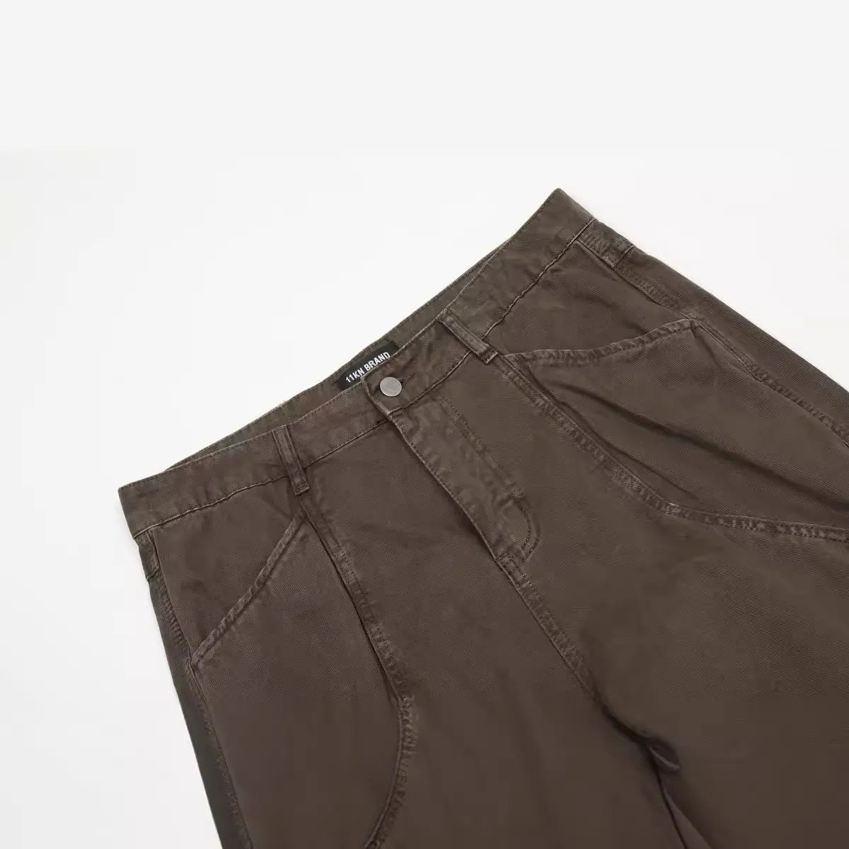 Men's brown straight-leg cotton trousers showing high-waist design and traditional straight-leg silhouette