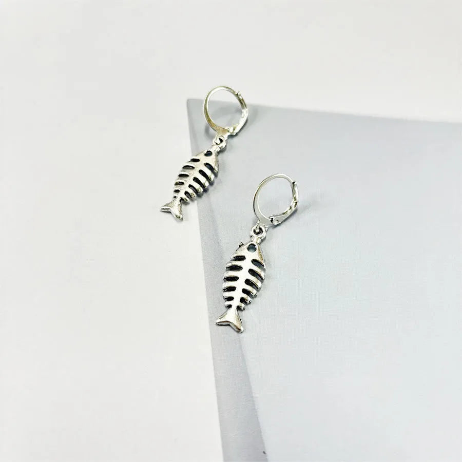 Retro fishbone design alloy necklace and matching earrings set on a dark background.