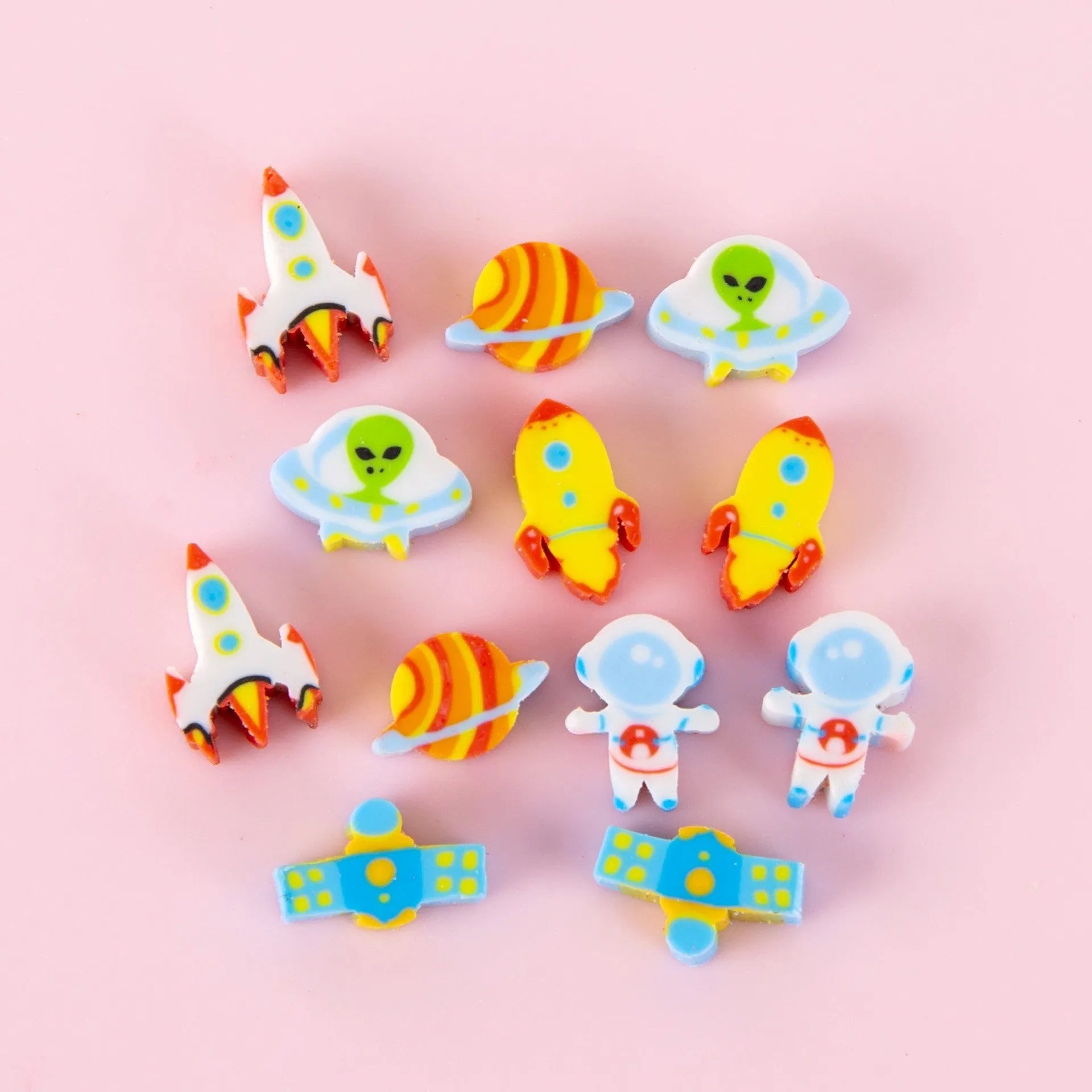 Assortment of fifty small cartoon-shaped rubber erasers in fruit and animal designs.