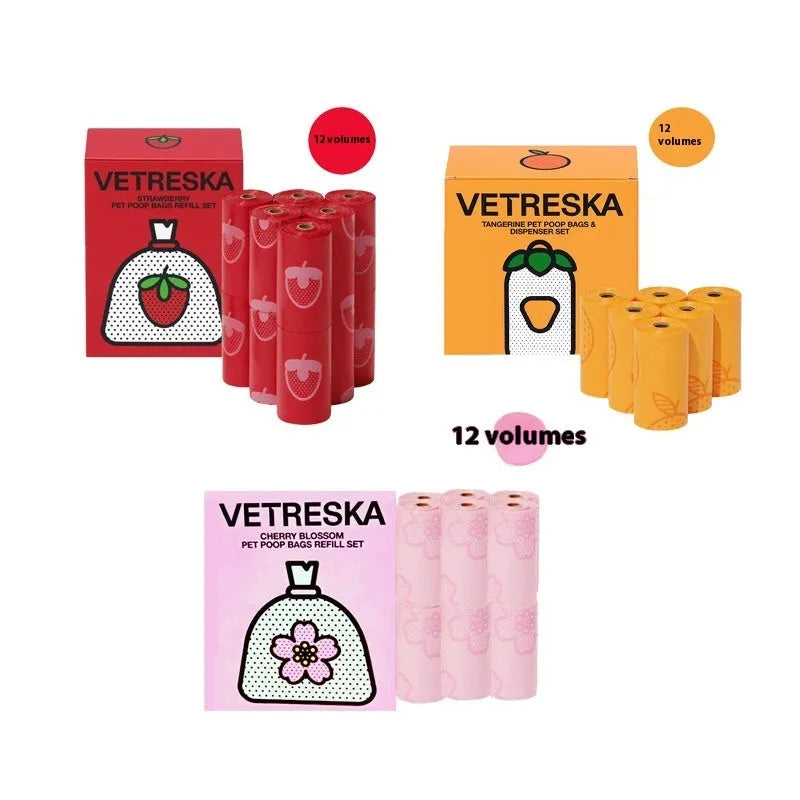 Portable plastic capsule dispenser for scented dog poo bags in strawberry, orange, and cherry blossom designs.