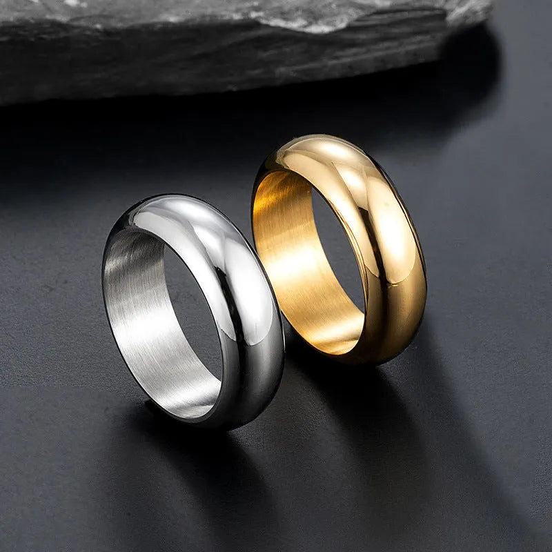 Glossy electroplated titanium steel ring shown in black, gold, and steel colour on a neutral background.