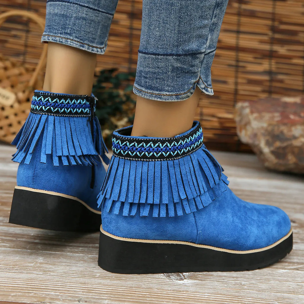 Women's black suede wedge ankle boots with side zipper and decorative tassel on a thick rubber sole.