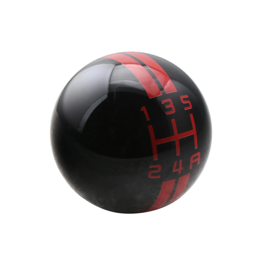 Black acrylic car gear shift knob showing 5-speed pattern with white lettering, next to three screw accessories.