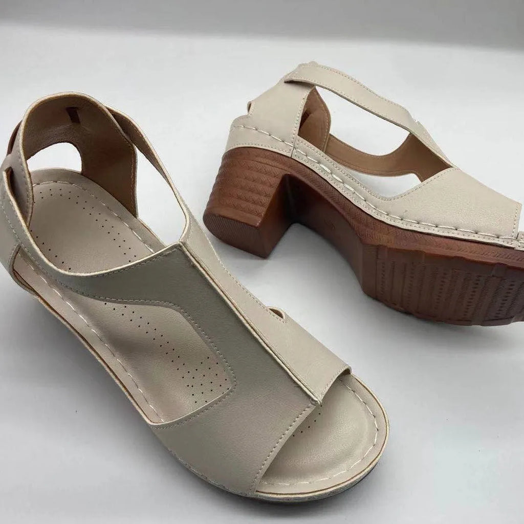 Women's white peep toe wedge sandals with a Roman style fish mouth toe and ankle buckle on a low rubber sole.