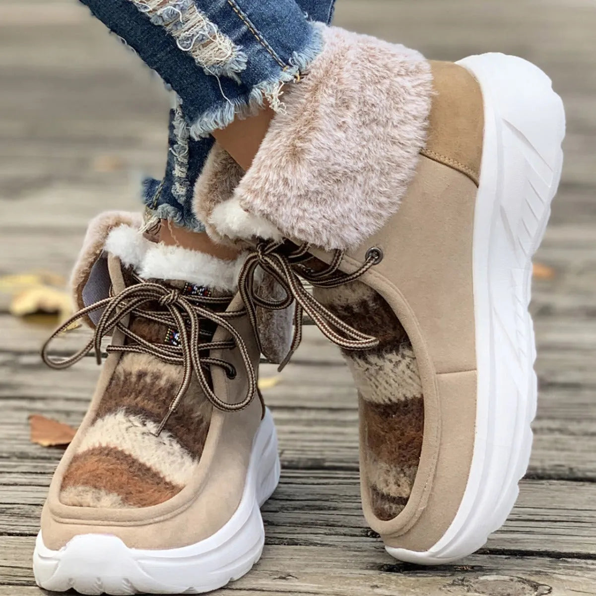 Women's beige lace-up snow boots with suede upper, thick rubber sole, and fuzzy lining on a white background.