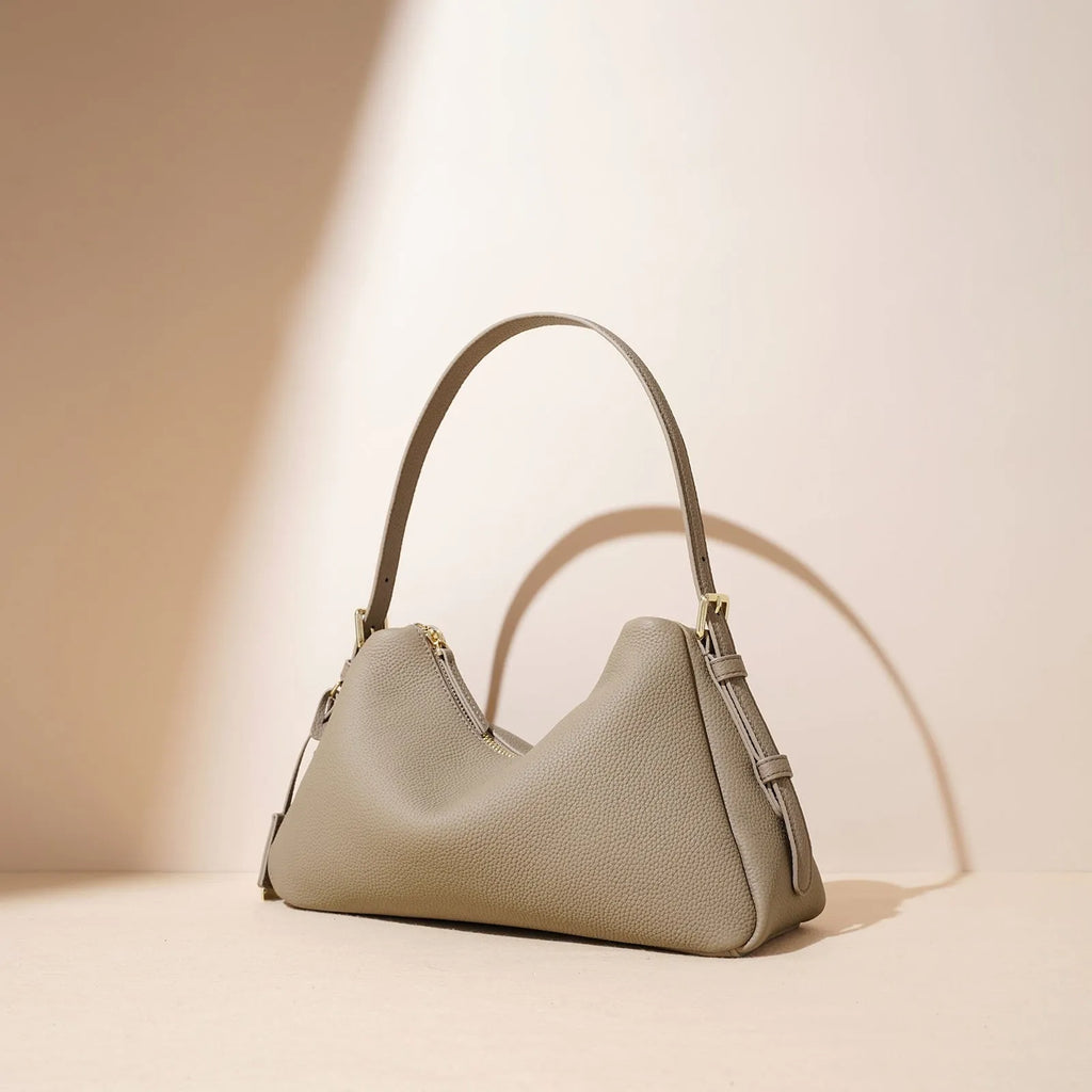 First layer cowhide leather pillow shape handbag in elephant gray with shoulder strap and open outer pocket