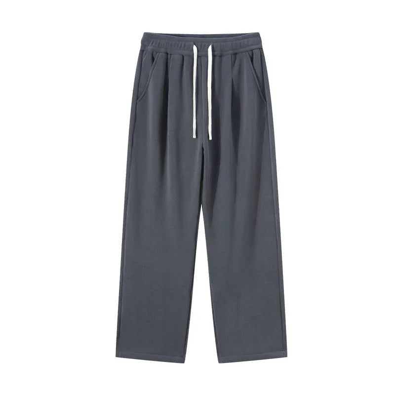 Men's apricot coloured loose-fit polar fleece trousers with a drawstring waistband, shown laid flat.