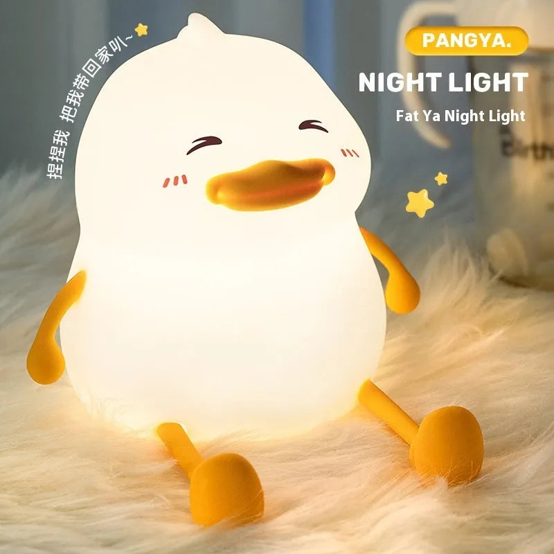 Chubby silicone desktop night light with phone holder showing soft LED illumination