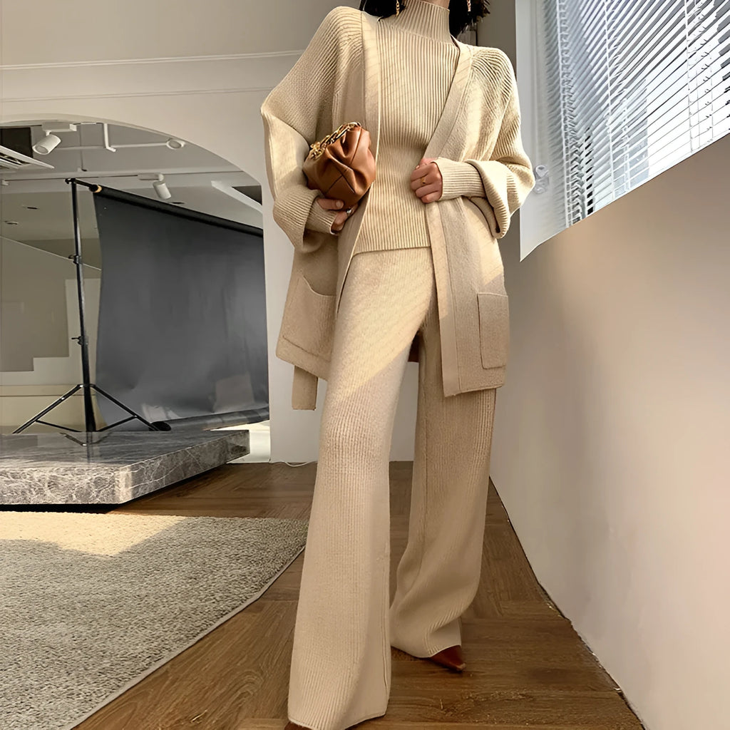Women's knitted three-piece suit set showing top, wide-leg pants, and sweater cardigan in solid colour with leather stitching