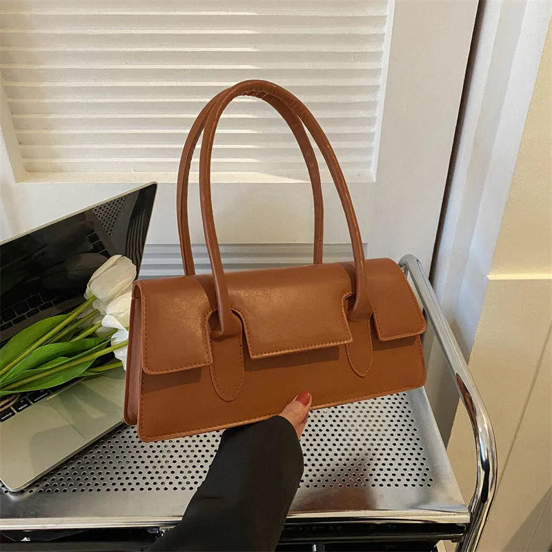 Women's retro style small square shoulder bag in four colours with adjustable strap and stitching detail