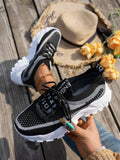 Women's Flyknit mesh lace-up sneakers in a selection of colours, showing round toe and flat rubber sole.